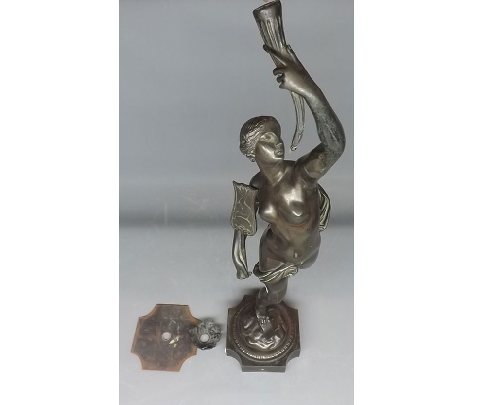 Large bronze metal figural table lamp, formed as a figure holding a torch, currently dis-