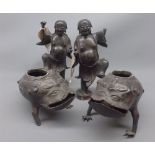 Pair of 20th century Japanese bronzed spelter models of figures riding toads, some damage throughout