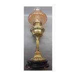 20th century brass based oil lamp with coloured glass shade