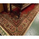 Large 20th century red ground wool floor rug decorated with stylised foliage, 140" long