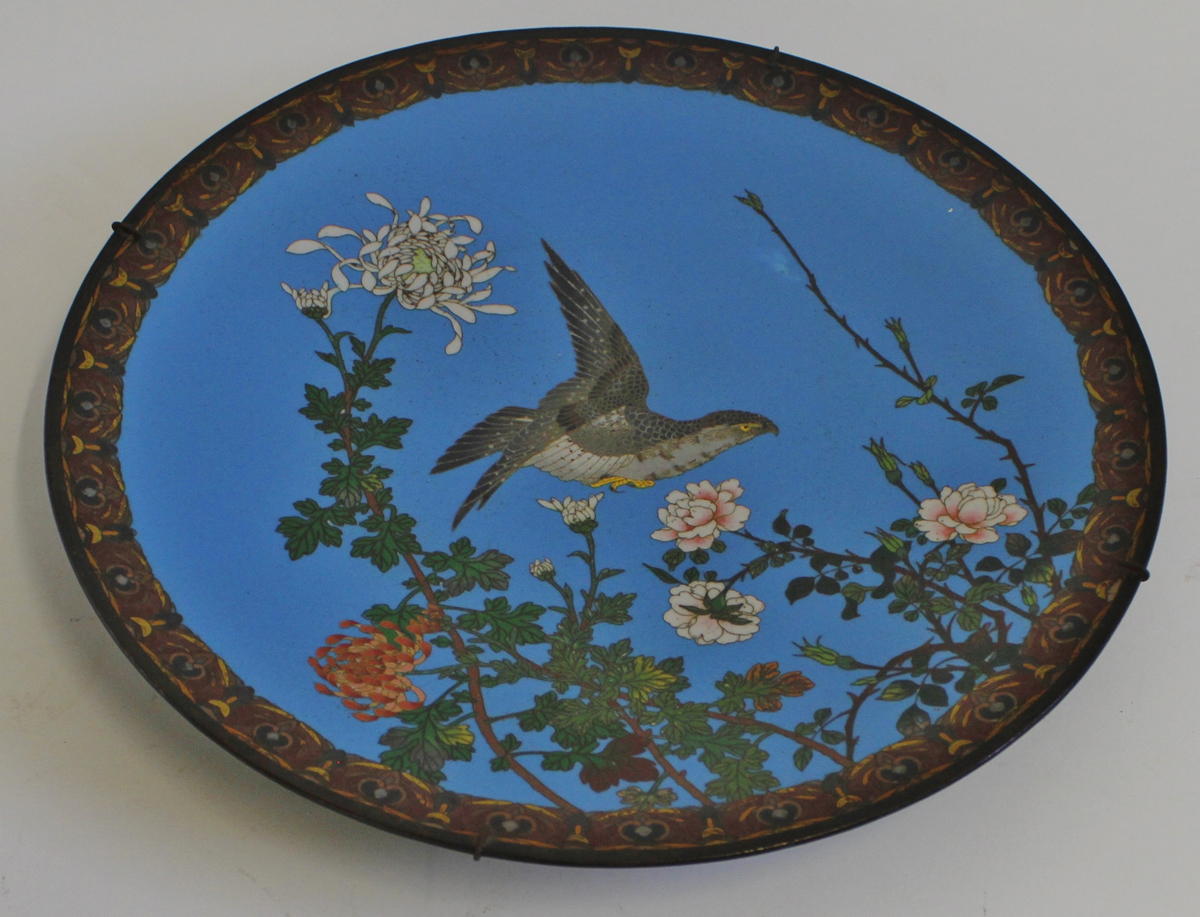 Japanese cloisonn enamel circular dish depicting a hawk in flight above flowers and foliage