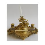 19th century gilt metal inkstand, of oval form, the centre with foliate candlestick above a