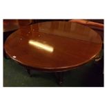 Very large Victorian mahogany extending circular dining table, formed as two sections with turned