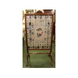 Edwardian mahogany framed fire screen, decorated with various silk work pictures