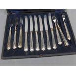 Cased set of dessert knives and forks, with white metal covered handles