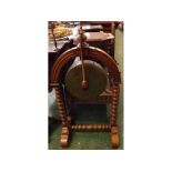 Late 19th century floorstanding dinner gong, on bobbin turned wooden frame, complete with striker,