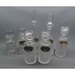 Collection: seven various 20th century clear glass decanters with various plated labels, largest 14"