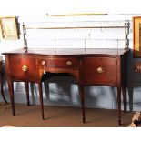 Regency period mahogany sideboard, of serpentine form, the back with a brass rail crested at the