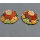 Pair of small Clarice Cliff Bizarre squat candlesticks, of circular form, 3 1/2" diameter