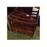 Mahogany four section Canterbury magazine rack, with drawer under, raised on tapering legs and brass