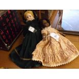 Two Heubach & Koppelsdorf dolls, one in dark green outfit, the other in flowing floral dress,