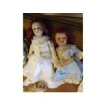 Mixed lot: one bisque headed doll plus one other, both approx 12" high (2)