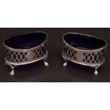 Pair of late Victorian open salts, each of oval form with blue glass inserts and pierced