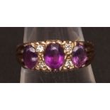 9ct gold amethyst and diamond ring, the three oval cut amethysts interspersed with four small single