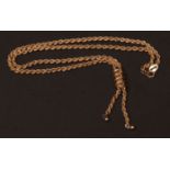 Modern 9ct gold rope twist necklace, having a stylised coil-shaped pendant and two ball-shaped