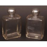 Two Edward VII silver lidded toiletry bottles, each of cut rectangular form, the clear glass