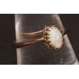Modern opal ring, the oval cabochon cut opal set in an unmarked mount