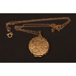 Modern 9ct gold circular locket, the front foliate engraved on a fine trace chain, 6.3gms gross