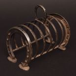 Late 19th century novelty toast rack, the end bars modelled as horseshoes with further strap work