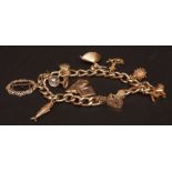 Modern 9ct gold charm bracelet, having ten various charms to include ballerina, television, fish,