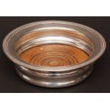 George V coaster, of circular form with applied reeded rim and ribbed body with ring turned treen