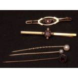 Mixed Lot: yellow metal stick pin with small pearl finials; a further garnet-set pin; a 9ct gold bar