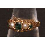 Late Victorian 18ct gold, emerald and pearl five stone ring, enclosed setting in a scroll and bead