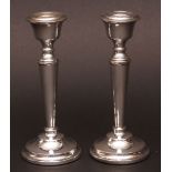 Pair of Elizabeth II candlesticks, each with detachable nozzles and urn-shaped sconces on tapering