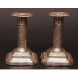 Two Edward VII squat candlesticks, each with fixed nozzles and drip pans on cylindrical columns