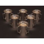 Six George VI spirit cups, each of polished tapering form and each with three cast and applied