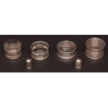 Mixed Lot: three various hallmarked silver napkin rings, each of circular form, together with two