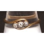 Three stone diamond cross-over ring, set with three round brilliant cut diamonds (0.20ct approx),