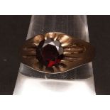 Gents 9ct gold ring, set with a circular dark red cut stone, hallmarked for Birmingham 1970,
