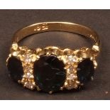 18ct gold three-stone sapphire and diamond ring, the three oval faceted sapphires accented with