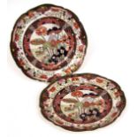Pair of Mason's Ironstone circular plates, the centres painted in colours with flowering foliage and