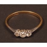 Three stone diamond ring, claw set in a pierced raised gallery, three small diamonds (0.30ct app),