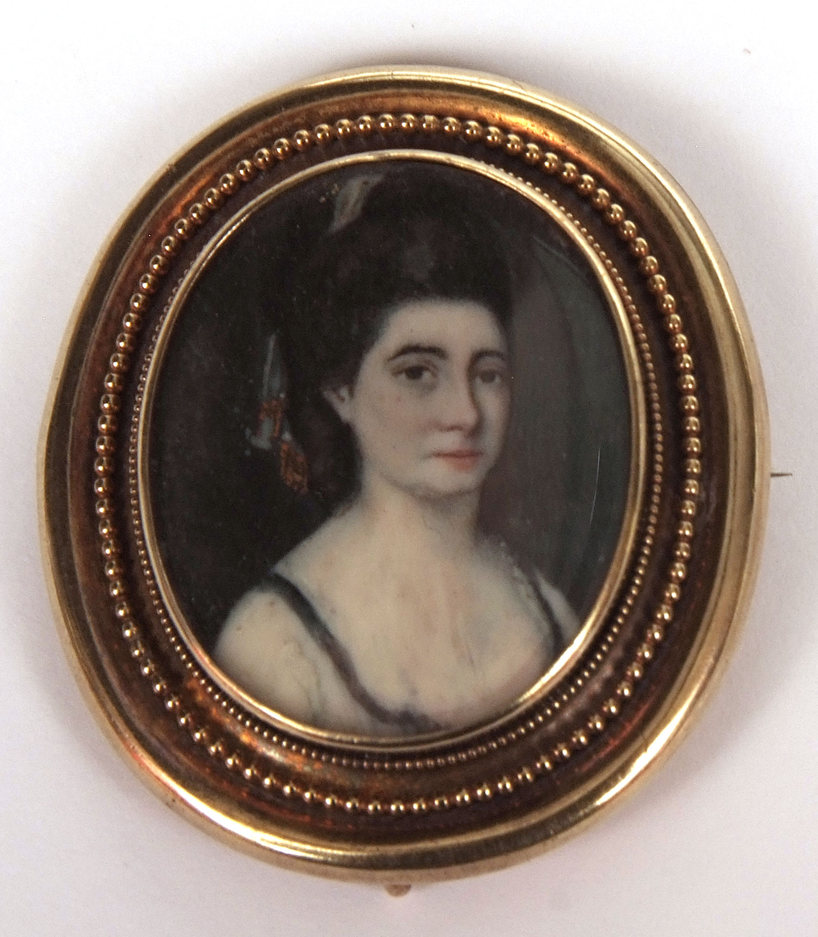 ENGLISH SCHOOL (19TH CENTURY) Head and shoulders portrait of a lady portrait miniature set in brooch