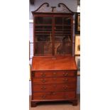 Mahogany bureau bookcase, with pierced swan neck pediment over glazed doors enclosing adjustable