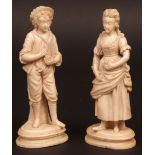 Pair of 19th century ivory carved figures of young man and woman in period costume, each clutching