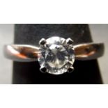 Precious metal single stone diamond ring, the brilliant cut diamond (0.65ct app) in a claw and peg