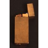 Second half of 20th century gold plated cigarette lighter, Must de Cartier, 87556V of typical reeded