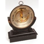 Late 19th century French brass cased aneroid barometer on stand, the drum-shaped case with ring