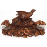 Unusual Bavarian carved treen inkstand crested with a game bird, flanked on either side with