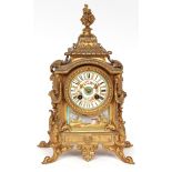 Late 19th century French gilt metal and porcelain mounted mantel clock, the shaped case with applied