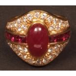 Modern 18ct gold diamond and ruby cluster ring, the centre set with a cabochon cut oval ruby between