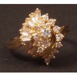 Modern 18ct gold and diamond cluster ring, a lozenge shaped spiral design set with ten baguette