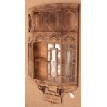 Cast iron aesthetic movement wall hanging cabinet with bevelled glass panels in the manner of Thomas