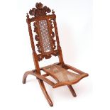 Decorative fruitwood folding campaign chair, the back crested with Prince of Wales feathers, central