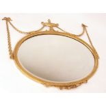 Adam style decorative oval wall mirror crested with an urn mount joined by floral garlands and