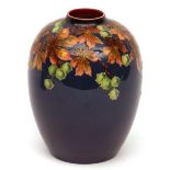 Royal Doulton baluster vase, painted in colours with floral design on a cobalt blue ground, 7" high